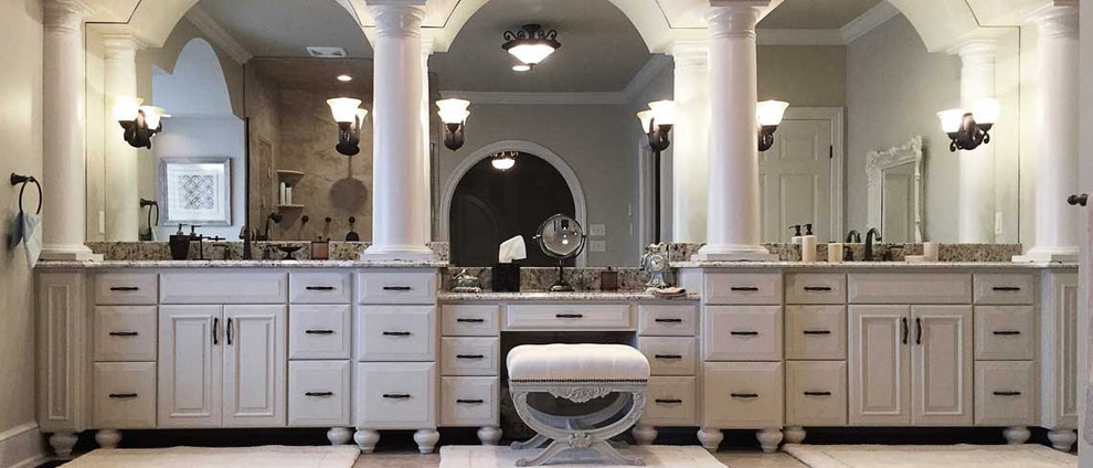 Example of a classic master bathroom design with raised-panel cabinets, white cabinets, an undermount sink and granite countertops