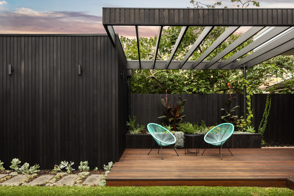 This is an example of a contemporary backyard deck in Melbourne with a pergola.