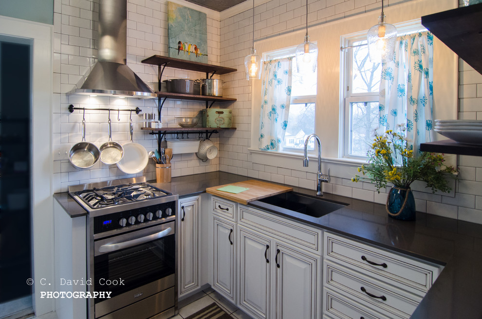 Inspiration for a small transitional u-shaped ceramic tile enclosed kitchen remodel with an undermount sink, raised-panel cabinets, white cabinets, solid surface countertops, white backsplash, subway tile backsplash, stainless steel appliances and no island