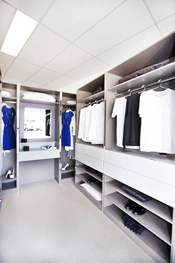 Photo of a large modern gender neutral walk-in wardrobe in Perth with flat-panel cabinets, grey cabinets and carpet.