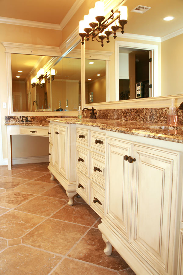 Bathroom - large transitional master travertine floor bathroom idea with raised-panel cabinets, white cabinets, beige walls, an undermount sink and granite countertops