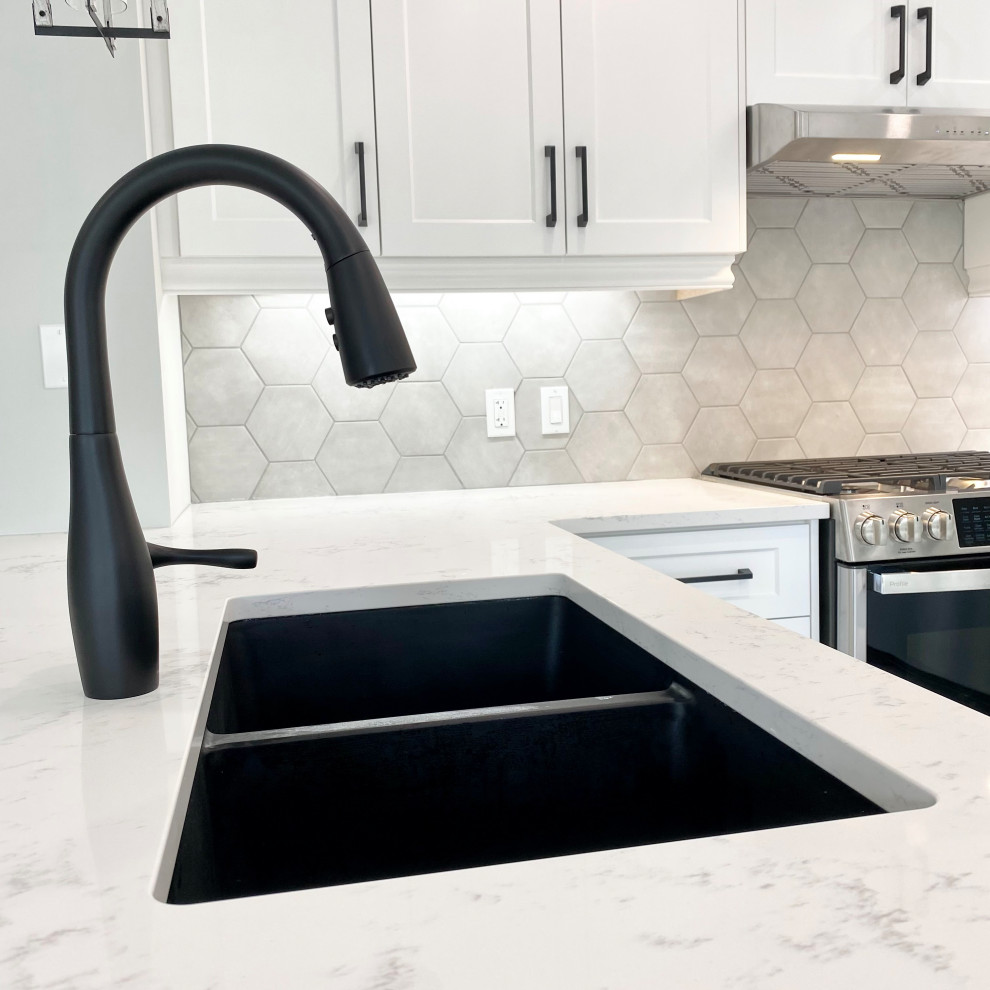 Example of a large transitional u-shaped porcelain tile and gray floor open concept kitchen design with an undermount sink, recessed-panel cabinets, white cabinets, quartzite countertops, gray backsplash, stainless steel appliances, a peninsula and white countertops