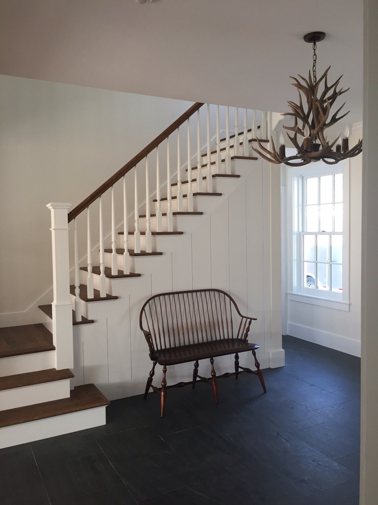 Design ideas for a mid-sized country wood straight staircase in Burlington with painted wood risers.