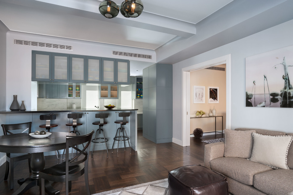 Mid-sized contemporary open concept family room in New York with medium hardwood floors, a freestanding tv, blue walls, no fireplace and brown floor.