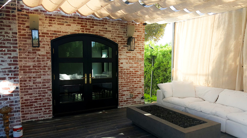 Inspiration for a small country backyard patio in Los Angeles with a fire feature, decking and a gazebo/cabana.