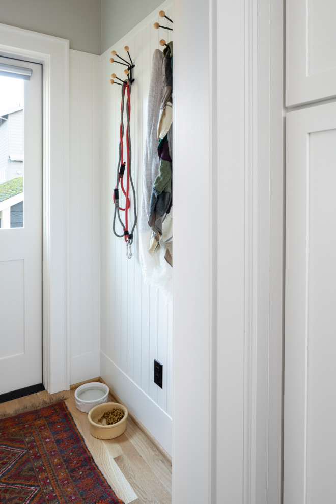 Design ideas for a small country mudroom in Seattle with grey walls, medium hardwood floors, a single front door and a white front door.