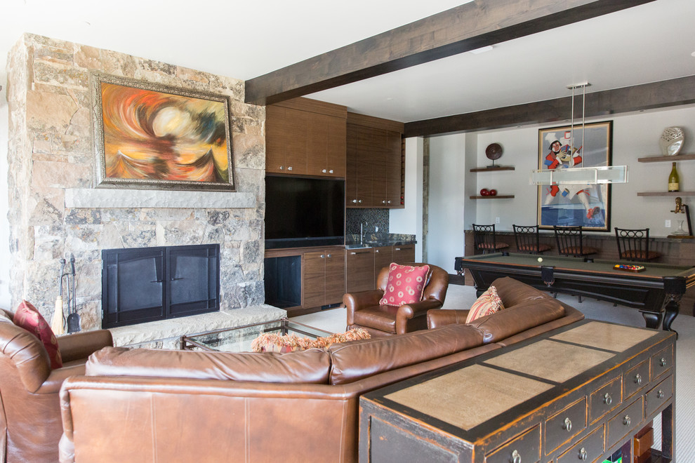 Inspiration for a transitional beige floor game room remodel in Salt Lake City with white walls, a standard fireplace, a stacked stone fireplace and a media wall