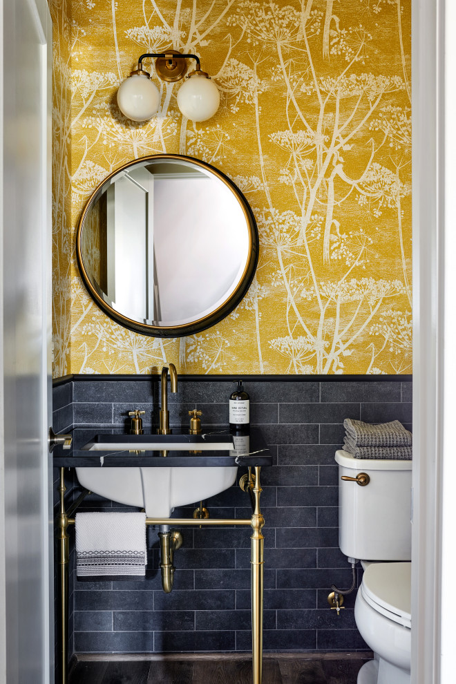 Industrial powder room in DC Metro with yellow walls and wallpaper.