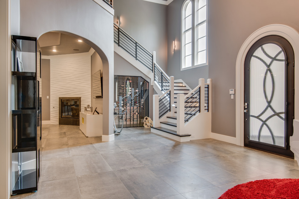 Inspiration for a transitional foyer in Dallas with concrete floors, a single front door, a glass front door and grey floor.