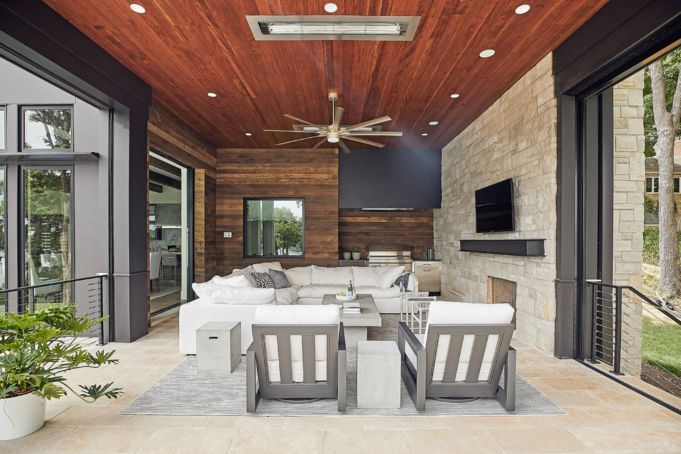 Inspiration for a contemporary patio in Minneapolis with tile and a roof extension.
