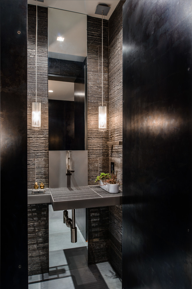 Photo of a contemporary powder room in Seattle with brown tile.