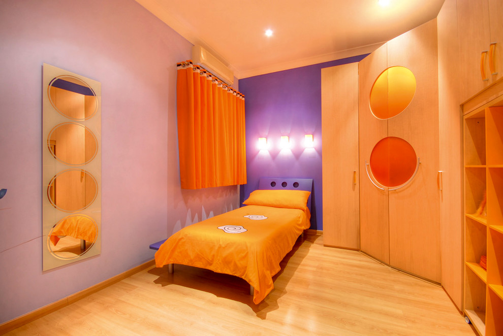 This is an example of a contemporary gender-neutral kids' bedroom for kids 4-10 years old in Other with purple walls and light hardwood floors.