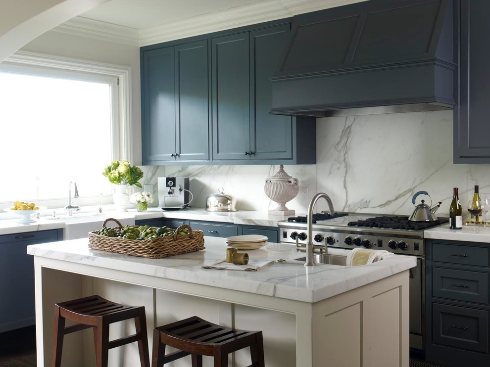 Inspiration for a traditional kitchen in San Francisco with a farmhouse sink, blue cabinets, marble benchtops, white splashback, stainless steel appliances and marble splashback.
