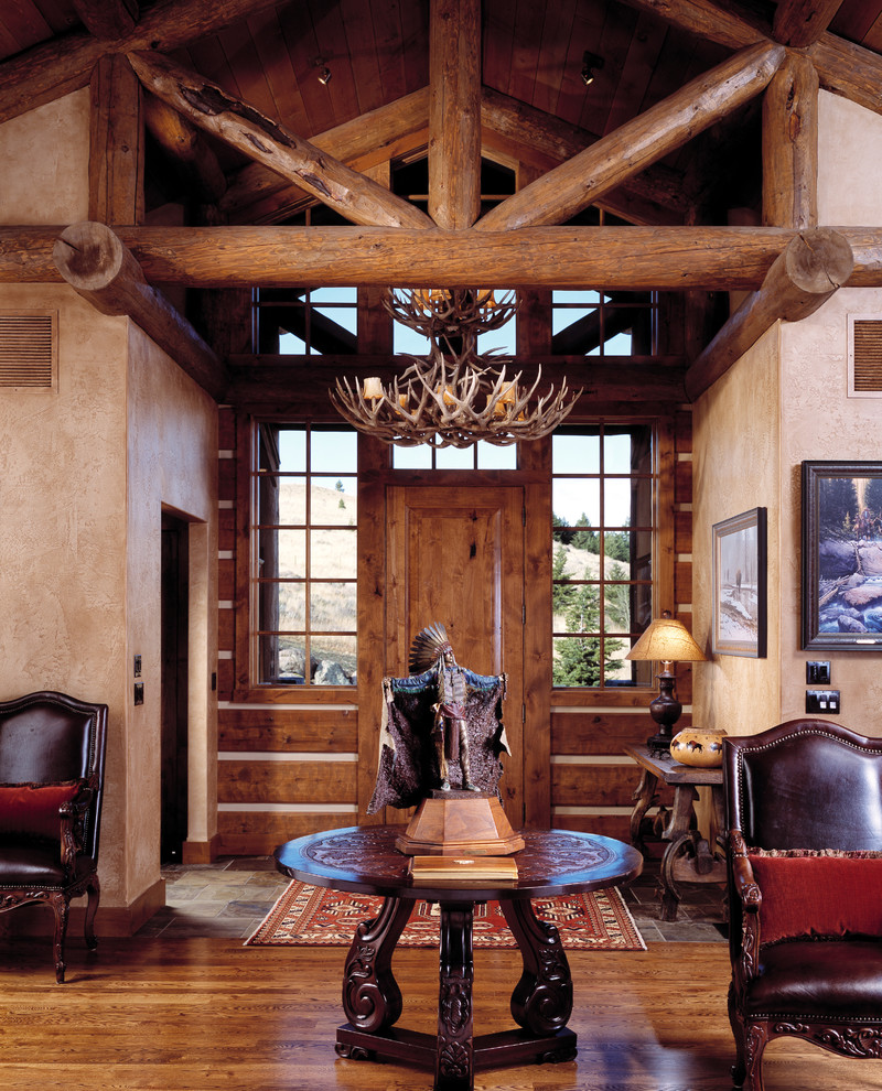 Inspiration for a mid-sized rustic medium tone wood floor and exposed beam foyer remodel with beige walls and a medium wood front door