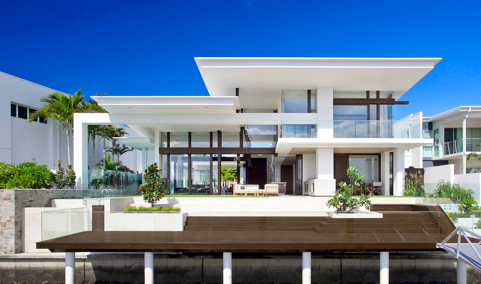 This is an example of an expansive contemporary two-storey white exterior in Brisbane with a flat roof.