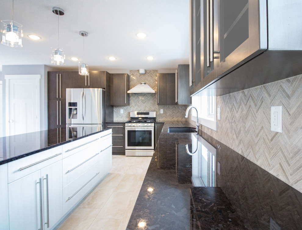 Photo of a mid-sized modern l-shaped kitchen in Edmonton with glass-front cabinets, dark wood cabinets, granite benchtops, an undermount sink, beige splashback, stone tile splashback, stainless steel appliances, ceramic floors, with island and beige floor.