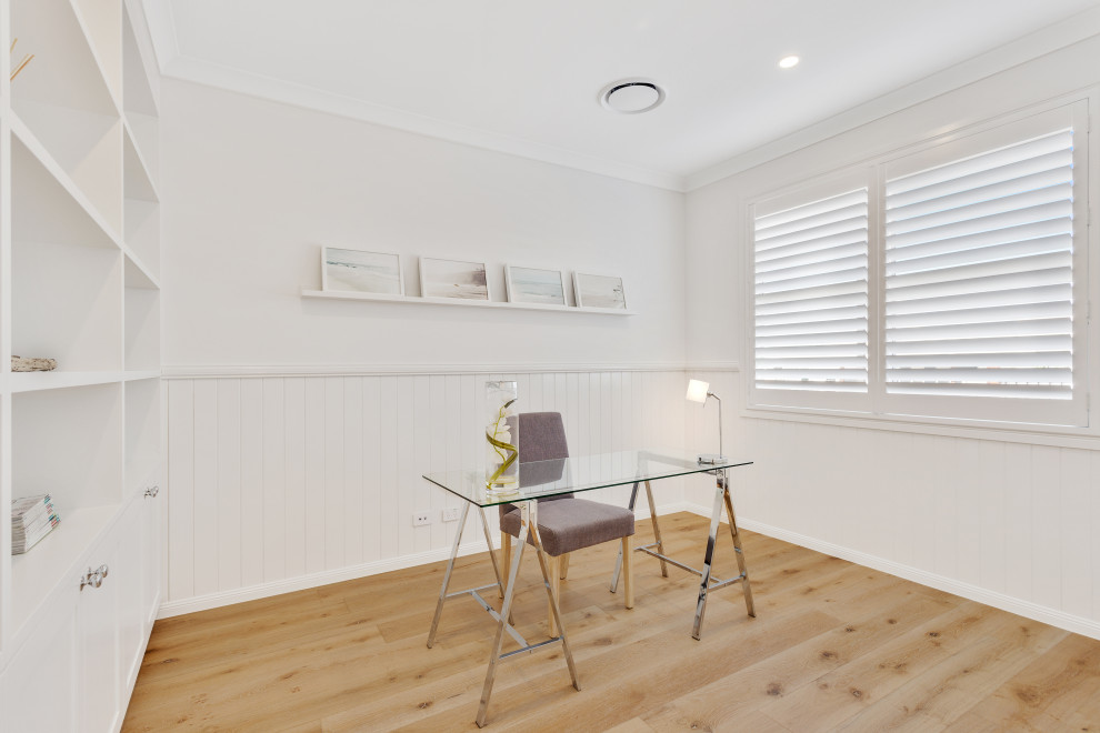 Inspiration for a large beach style study room in Brisbane with white walls, light hardwood floors, no fireplace, a freestanding desk, yellow floor and decorative wall panelling.