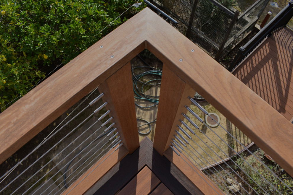 Minimalist backyard second story cable railing deck photo