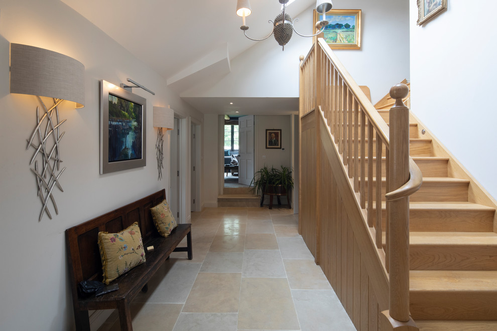 This is an example of a large traditional hallway in Hampshire with white walls, limestone floors and pink floor.