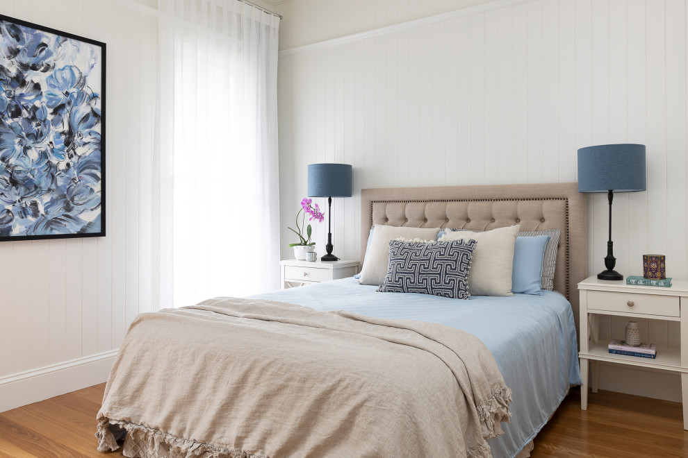 This is an example of a large contemporary guest bedroom in Brisbane with white walls and light hardwood floors.