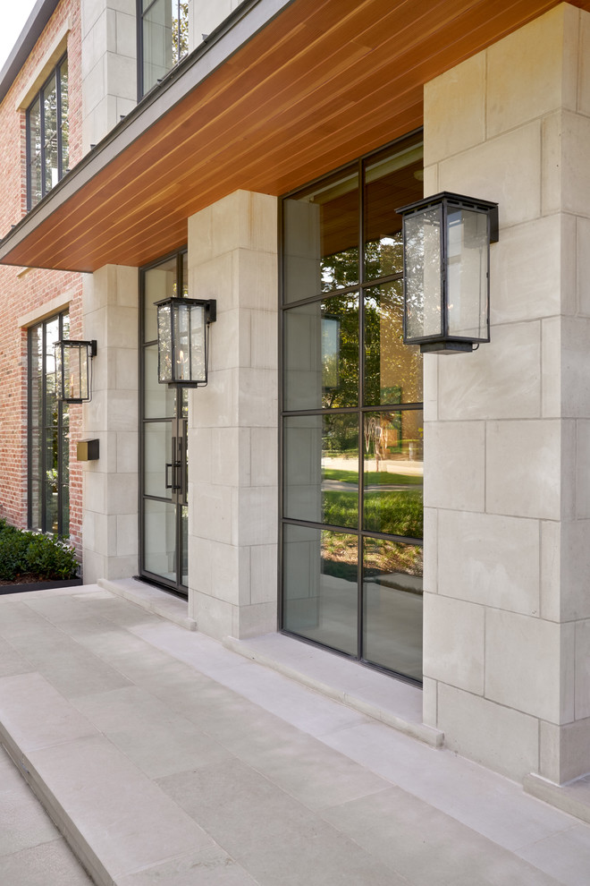 Beverly | 2018 - Example of a large transitional brown two-story brick gable roof design in Dallas with a metal roof