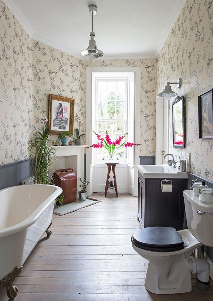 Photo of a large traditional kids bathroom in Edinburgh with a claw-foot tub, dark hardwood floors, a console sink, brown floor, grey cabinets, a one-piece toilet, laminate benchtops, white benchtops and shaker cabinets.