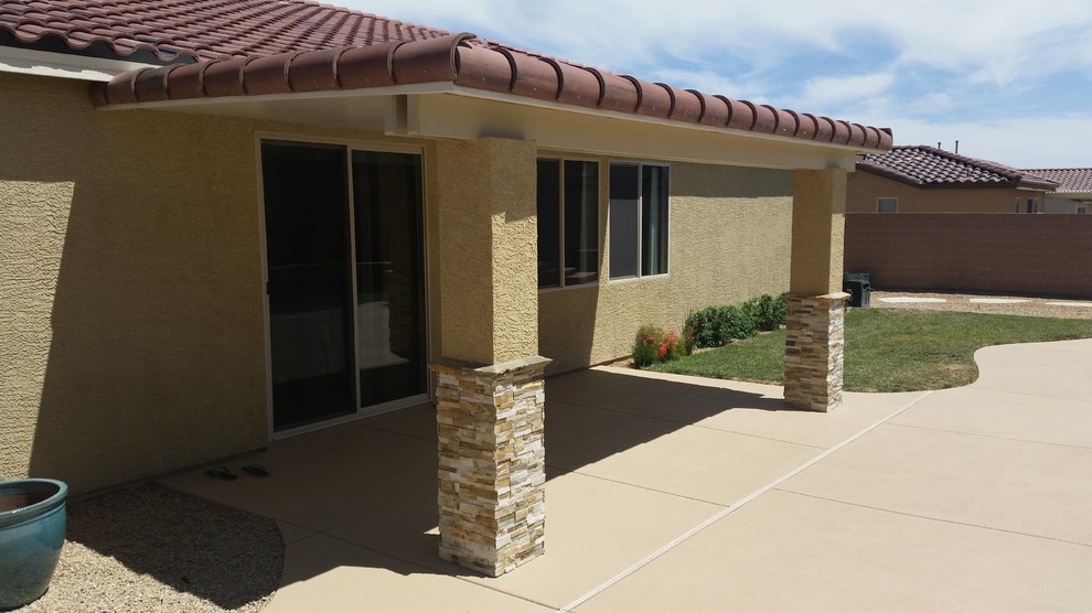 This is an example of a country backyard patio in Las Vegas with an awning.