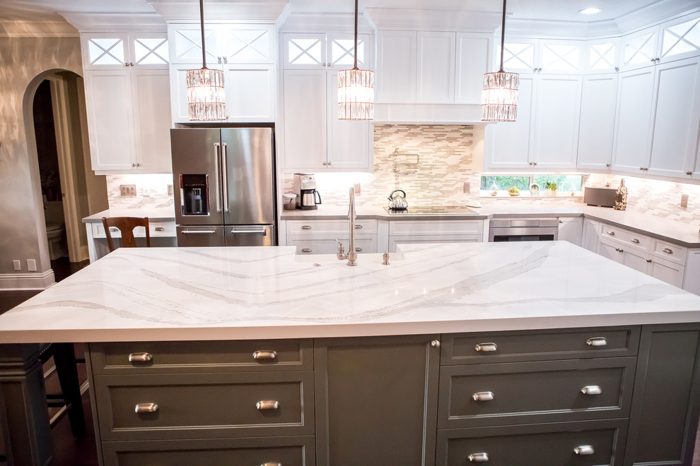 Large transitional u-shaped separate kitchen in Miami with a farmhouse sink, recessed-panel cabinets, white cabinets, quartzite benchtops, multi-coloured splashback, matchstick tile splashback, stainless steel appliances, dark hardwood floors, with island, brown floor and white benchtop.