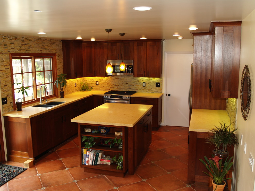 Photo of a mid-sized mediterranean eat-in kitchen in Los Angeles with a double-bowl sink, shaker cabinets, dark wood cabinets, marble benchtops, multi-coloured splashback, matchstick tile splashback, stainless steel appliances, ceramic floors and with island.