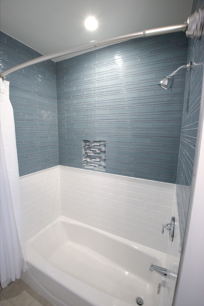 Small transitional bathroom in Orange County with an alcove tub, a shower/bathtub combo, blue tile and glass tile.