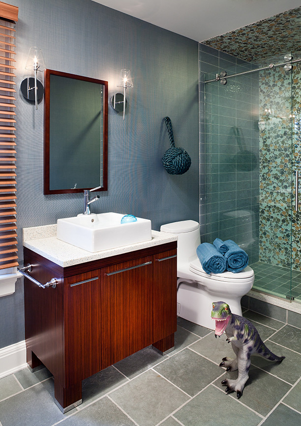 Mid-sized modern kids bathroom in New York with flat-panel cabinets, dark wood cabinets, an alcove shower, a one-piece toilet, blue tile, mosaic tile, blue walls, slate floors, a vessel sink, recycled glass benchtops, blue floor, a sliding shower screen and white benchtops.