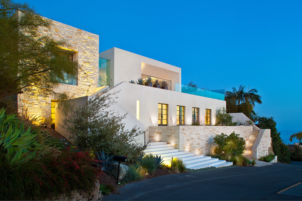 Design ideas for a contemporary exterior in San Diego with stone veneer and a flat roof.