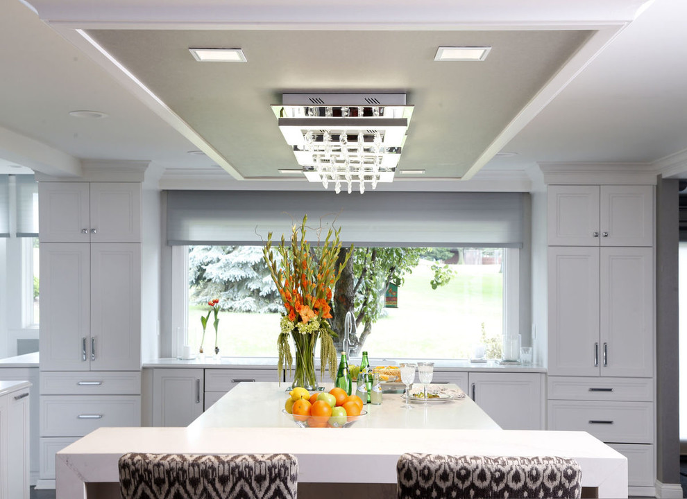 Kitchen - transitional porcelain tile and gray floor kitchen idea in Cedar Rapids with recessed-panel cabinets, white cabinets and glass countertops