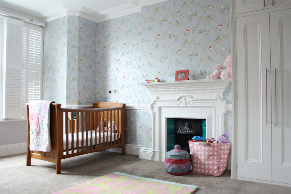 This is an example of a transitional gender-neutral nursery in London with multi-coloured walls and carpet.