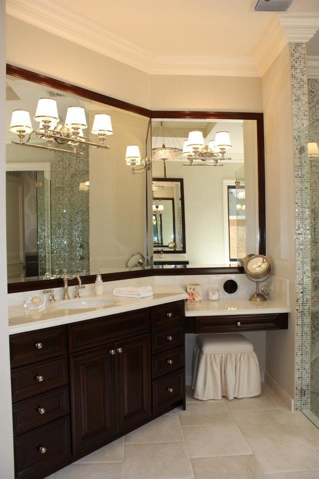 Photo of a large traditional master bathroom in Miami with raised-panel cabinets, dark wood cabinets, marble benchtops, a drop-in tub, beige tile, stone tile and marble floors.