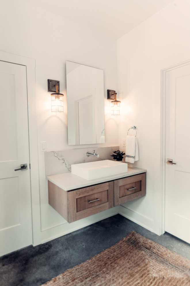 Photo of a mid-sized beach style kids bathroom in Other with light wood cabinets, a corner shower, a two-piece toilet, blue tile, glass tile, white walls, concrete floors, granite benchtops, a hinged shower door, white benchtops, a single vanity and a floating vanity.