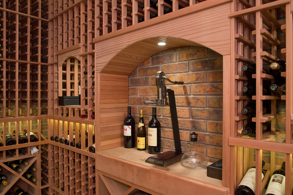 Photo of a large traditional wine cellar in Phoenix with travertine floors and diamond bins.
