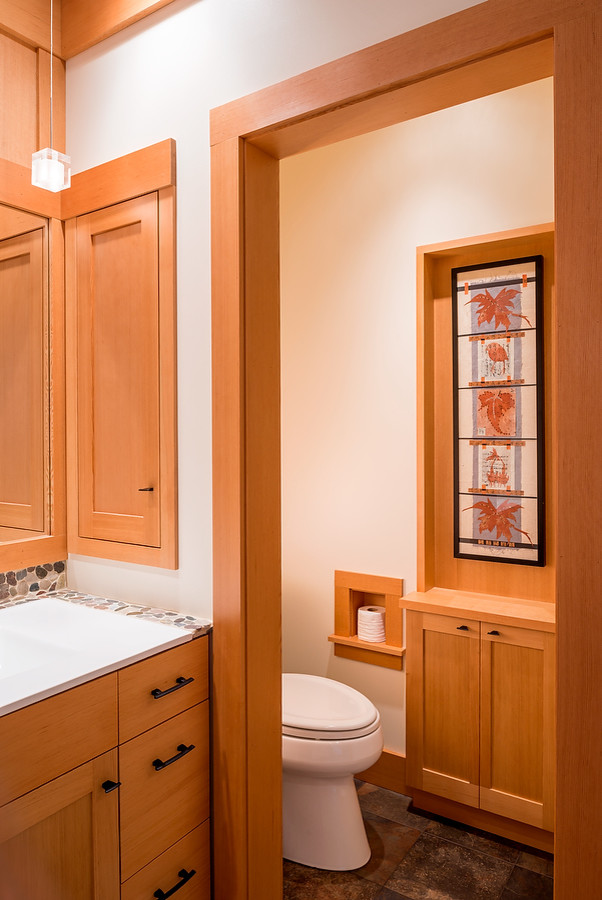 Photo of a mid-sized transitional 3/4 bathroom in Seattle with recessed-panel cabinets, light wood cabinets, tile benchtops, multi-coloured tile, pebble tile, a drop-in sink, an open shower, a two-piece toilet, beige walls and slate floors.