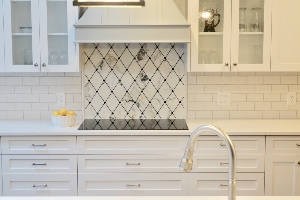 Large transitional galley medium tone wood floor and brown floor eat-in kitchen photo in Cleveland with an undermount sink, shaker cabinets, white cabinets, quartzite countertops, white backsplash, subway tile backsplash, stainless steel appliances and a peninsula