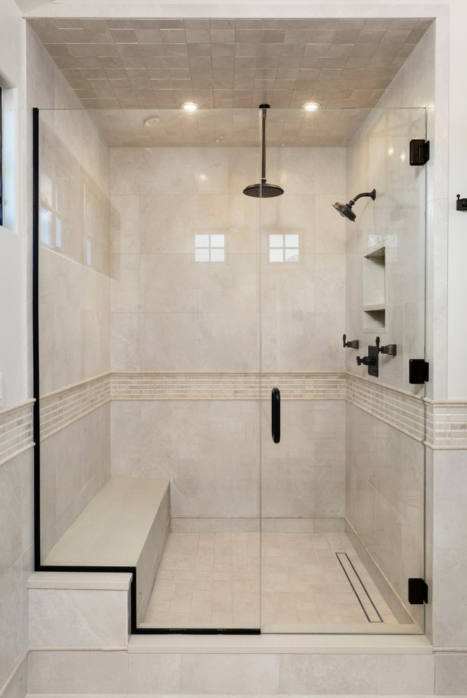 This is an example of a large traditional 3/4 bathroom in Denver with raised-panel cabinets, white cabinets, an alcove shower, beige tile, stone tile, beige walls, limestone floors, an undermount sink, limestone benchtops, beige floor and a hinged shower door.