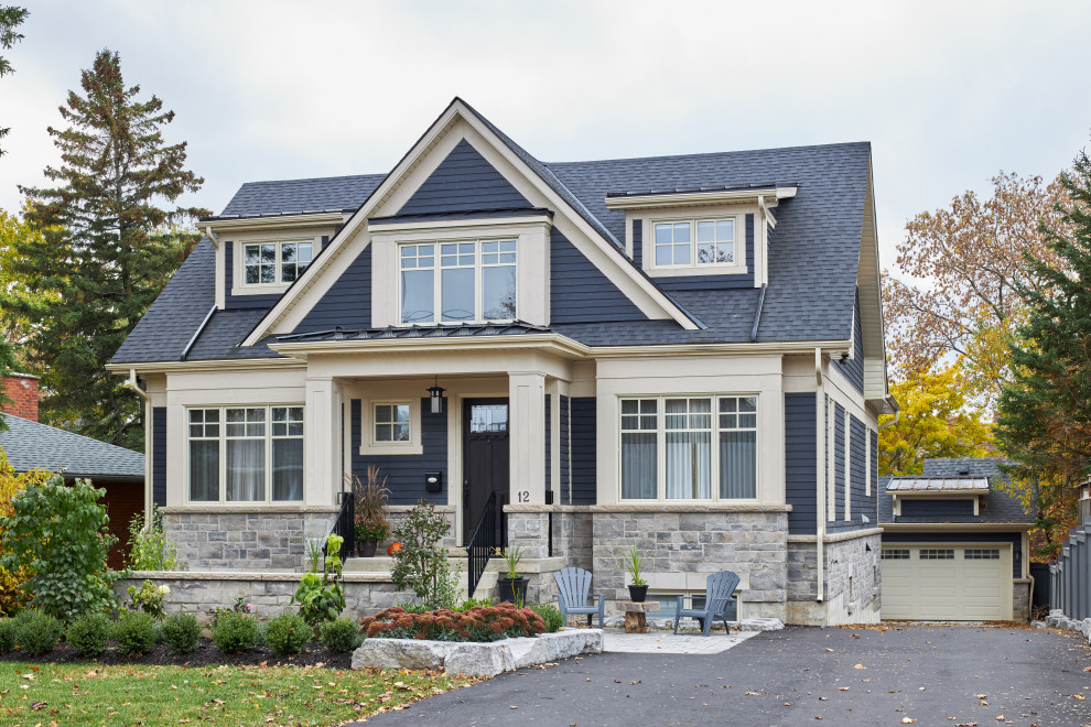 Inspiration for a large traditional two-storey blue house exterior in Toronto with wood siding, a gable roof and a shingle roof.