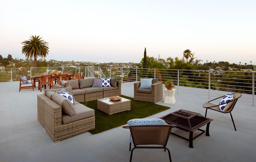 This is an example of a contemporary rooftop and rooftop deck in Other with a fire feature and no cover.