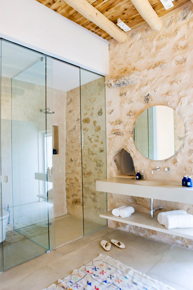 Inspiration for a large mediterranean 3/4 bathroom in Other with open cabinets, a curbless shower, a one-piece toilet, beige walls, ceramic floors and an integrated sink.