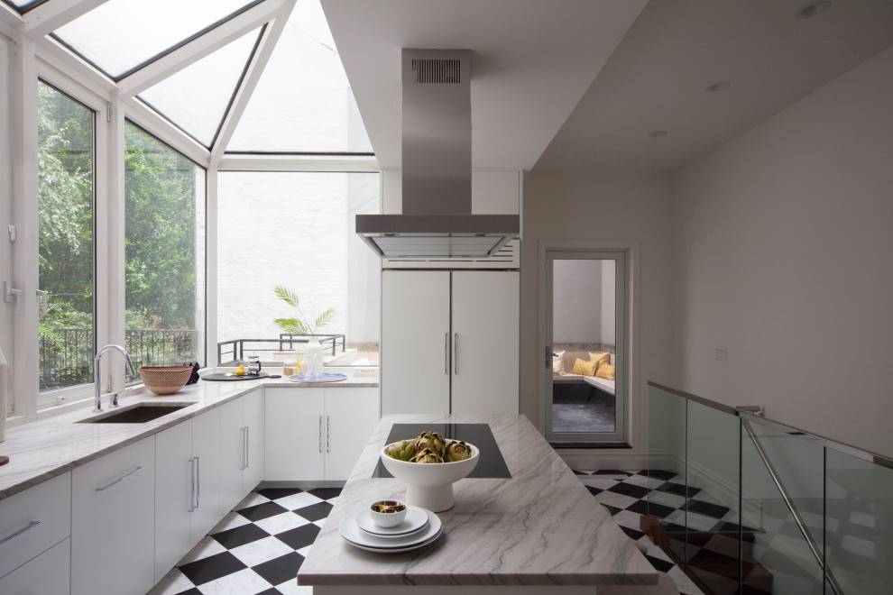 This is an example of a large modern l-shaped separate kitchen in New York with a single-bowl sink, flat-panel cabinets, white cabinets, marble benchtops, stainless steel appliances, marble floors, with island, white floor and grey benchtop.