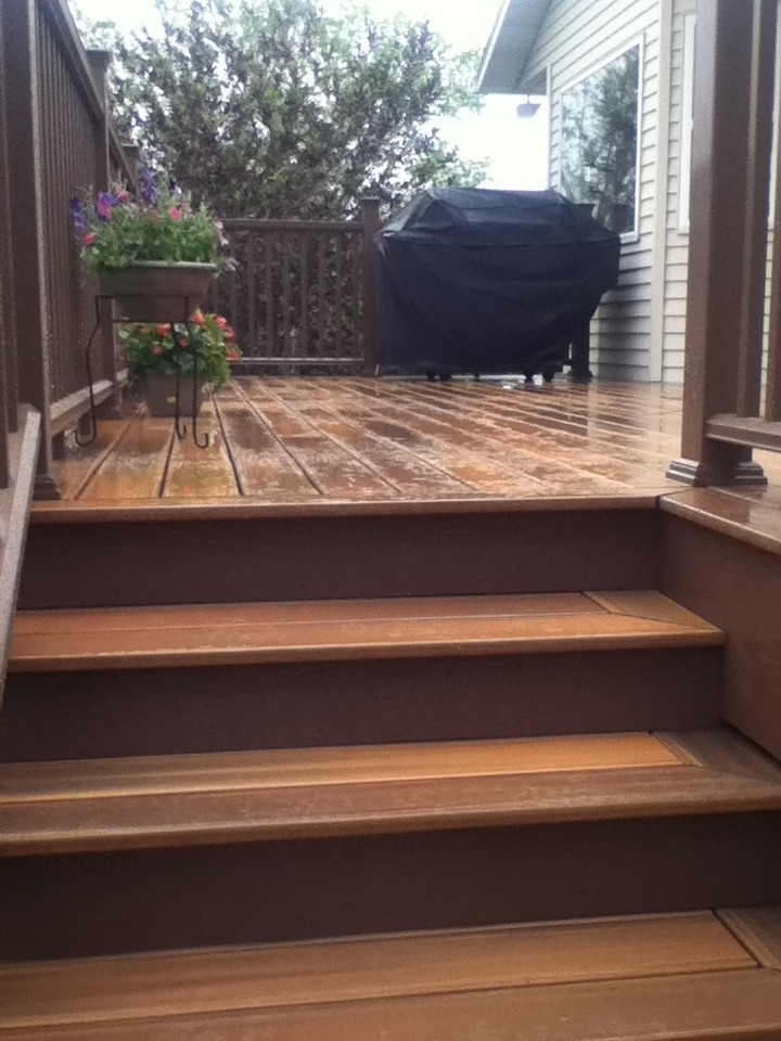 Large island style backyard deck photo with no cover