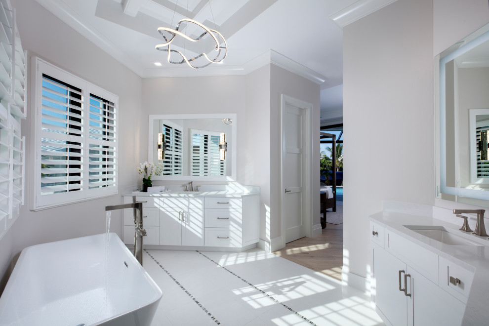 Design ideas for a beach style master bathroom in Miami with a freestanding tub.