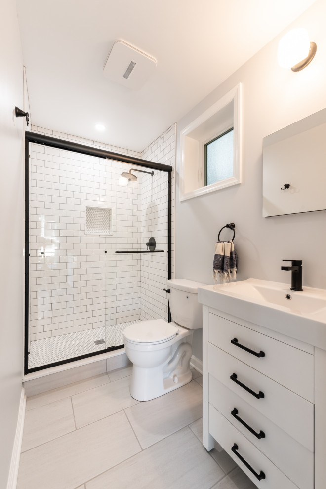 Inspiration for a small contemporary 3/4 bathroom in DC Metro with furniture-like cabinets, white cabinets, an alcove shower, white tile, subway tile, white walls, mosaic tile floors, a console sink, solid surface benchtops, grey floor, a sliding shower screen, white benchtops, a single vanity and a built-in vanity.