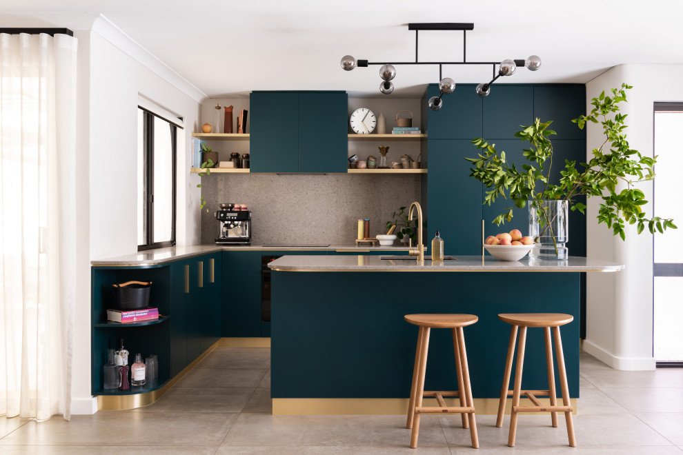 This is an example of a mid-sized contemporary l-shaped open plan kitchen in Perth with a single-bowl sink, green cabinets, quartz benchtops, grey splashback, engineered quartz splashback, cement tiles, with island, grey floor and grey benchtop.
