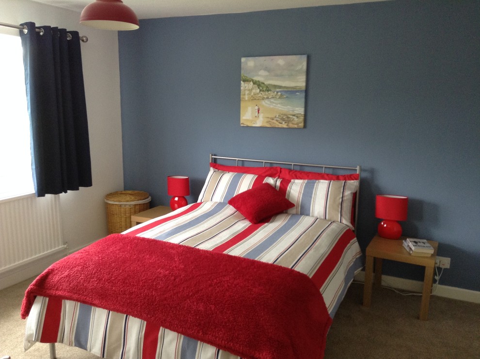 This is an example of a mid-sized contemporary guest bedroom in Cheshire with blue walls, carpet and no fireplace.