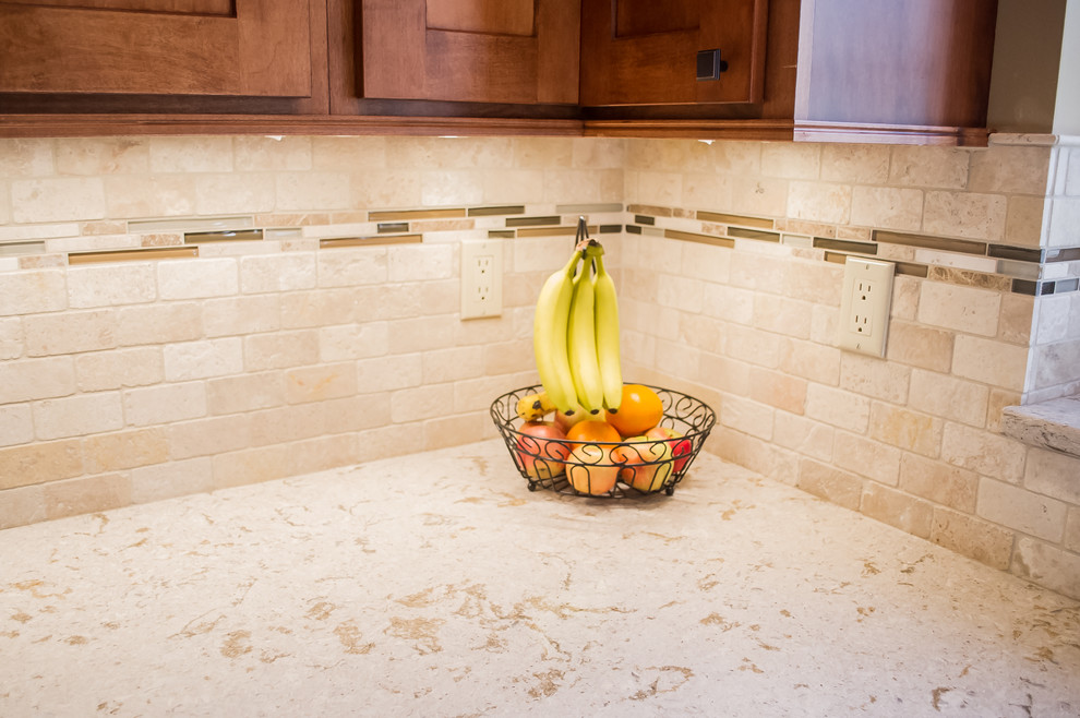 Mid-sized minimalist u-shaped vinyl floor eat-in kitchen photo with recessed-panel cabinets, medium tone wood cabinets, beige backsplash, ceramic backsplash, stainless steel appliances, a peninsula, an undermount sink and granite countertops
